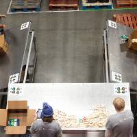 Birds eye view of a group of people loading food into cardboard boxes